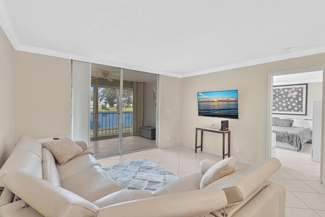 living room featuring ceiling fan, light tile patterned flooring, crown molding, and a textured ceiling