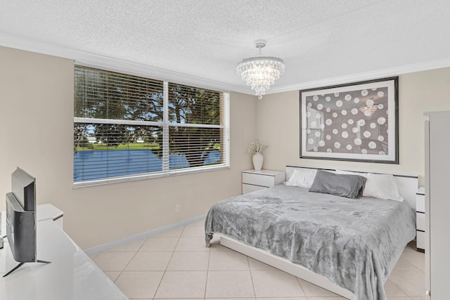 tiled bedroom featuring an inviting chandelier, ornamental molding, and a textured ceiling