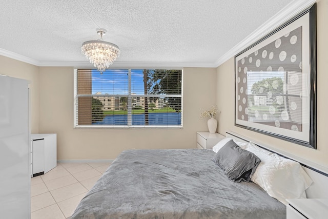 bedroom with a notable chandelier, light tile patterned flooring, a textured ceiling, crown molding, and refrigerator