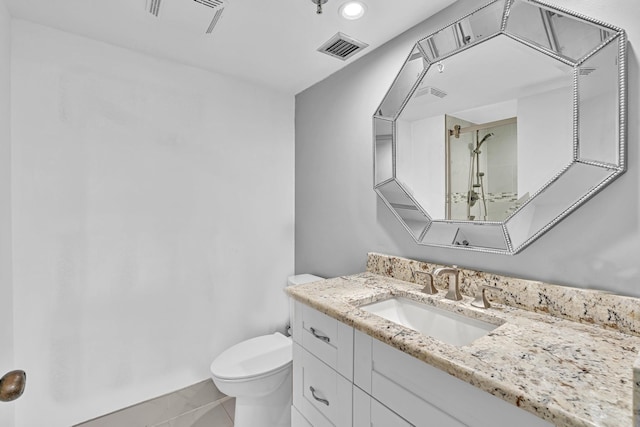 bathroom featuring tile patterned floors, vanity, and toilet