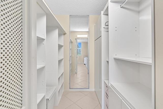 spacious closet featuring light tile patterned floors