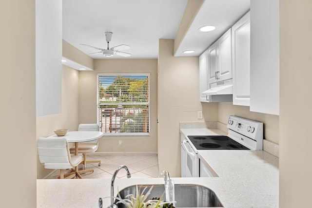 kitchen featuring ceiling fan, electric range, sink, light tile patterned flooring, and white cabinetry