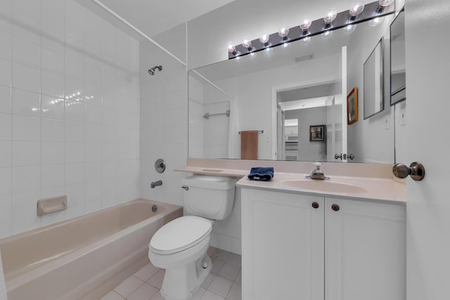 full bathroom featuring toilet, vanity, tile patterned floors, and tiled shower / bath