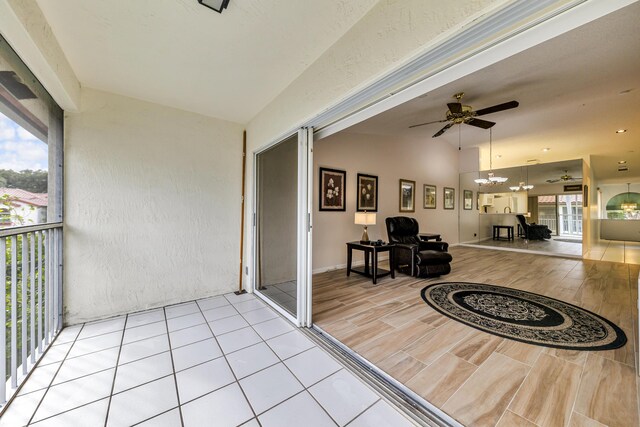 interior space with ceiling fan