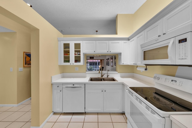 kitchen with white cabinetry, sink, white appliances, and light tile patterned flooring