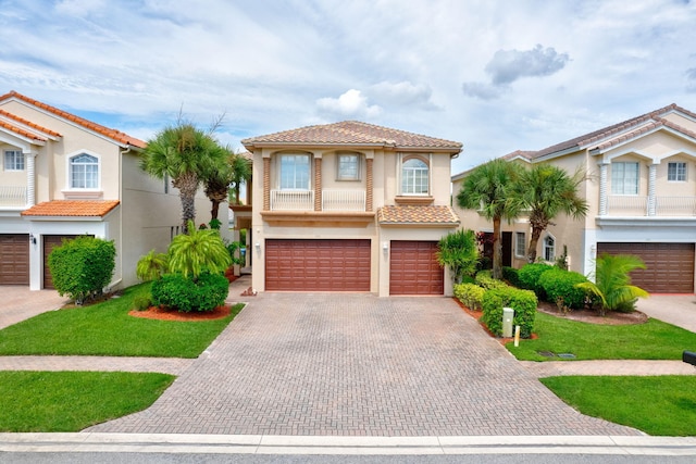 mediterranean / spanish home featuring a garage and a front lawn