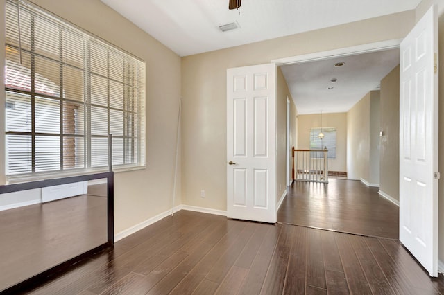 interior space featuring dark wood-type flooring and ceiling fan