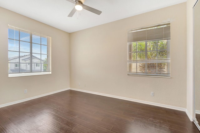 unfurnished room featuring ceiling fan and dark hardwood / wood-style flooring