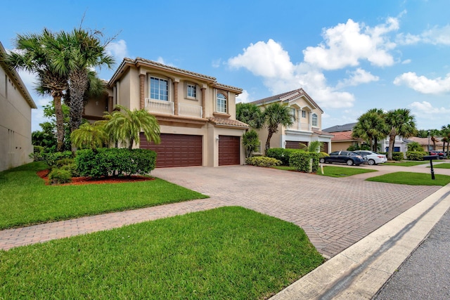 mediterranean / spanish-style home featuring a garage and a front lawn