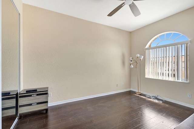 empty room featuring ceiling fan and dark hardwood / wood-style floors