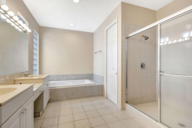 bathroom featuring tile patterned flooring, shower with separate bathtub, and vanity