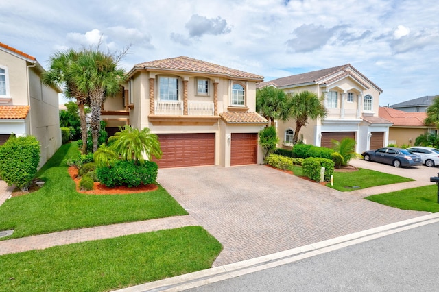 mediterranean / spanish-style house featuring a front yard and a garage