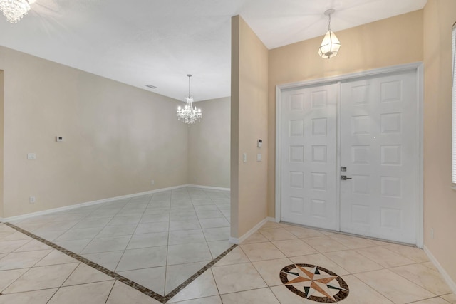 tiled entryway featuring an inviting chandelier