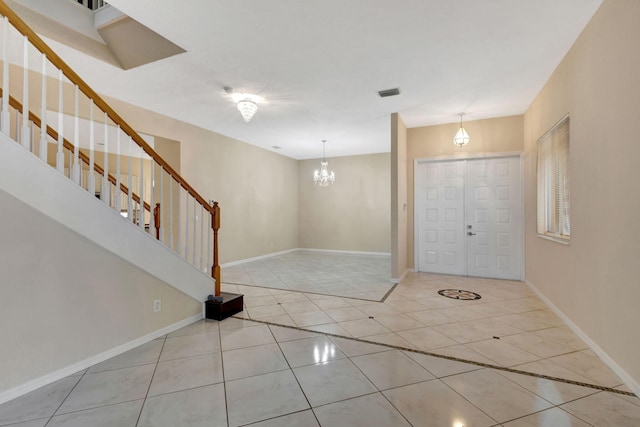 foyer featuring light tile patterned floors and an inviting chandelier