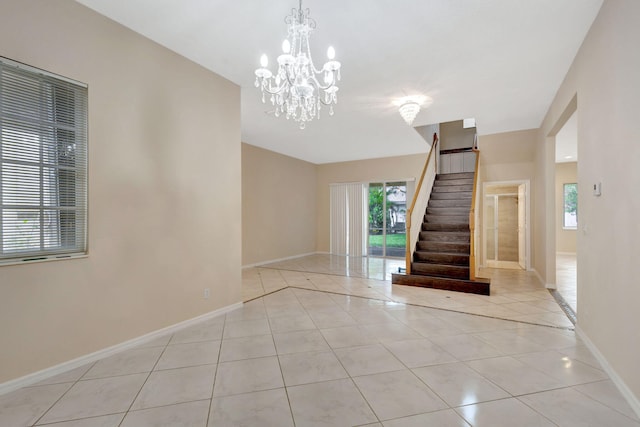 empty room featuring light tile patterned floors and an inviting chandelier