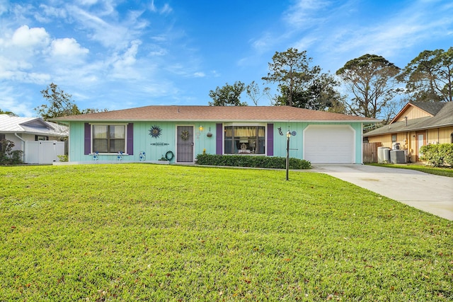 ranch-style house with a garage, a front yard, and central AC unit