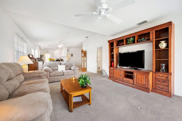 living room featuring light carpet and ceiling fan