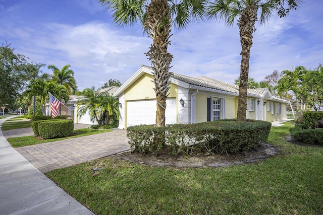 view of front of property with a garage and a front yard