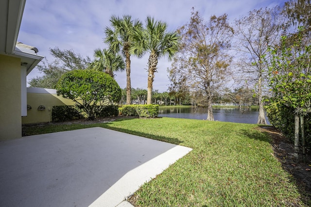 view of yard featuring a water view and a patio area