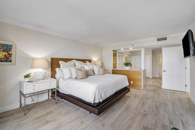 bedroom featuring light wood-type flooring and crown molding