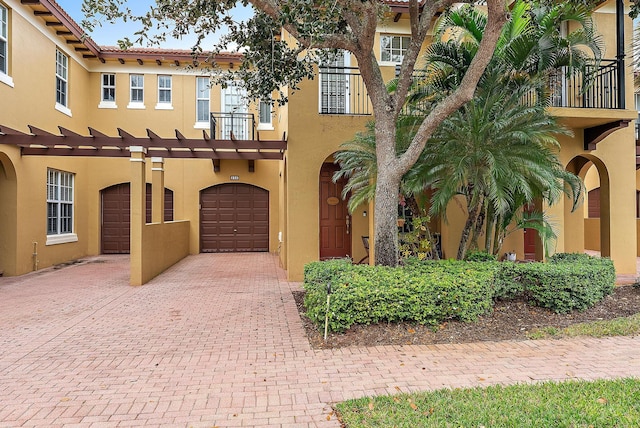 mediterranean / spanish-style house with a balcony and a garage