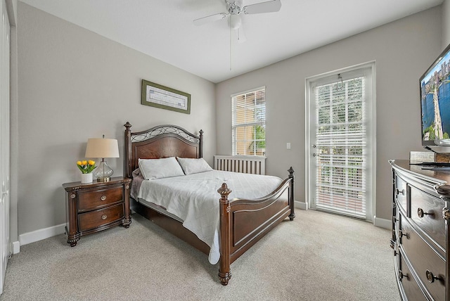 carpeted bedroom with ceiling fan and access to exterior