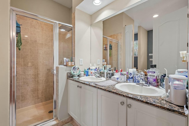 bathroom featuring walk in shower and vanity