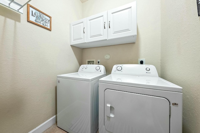 washroom with cabinets and separate washer and dryer