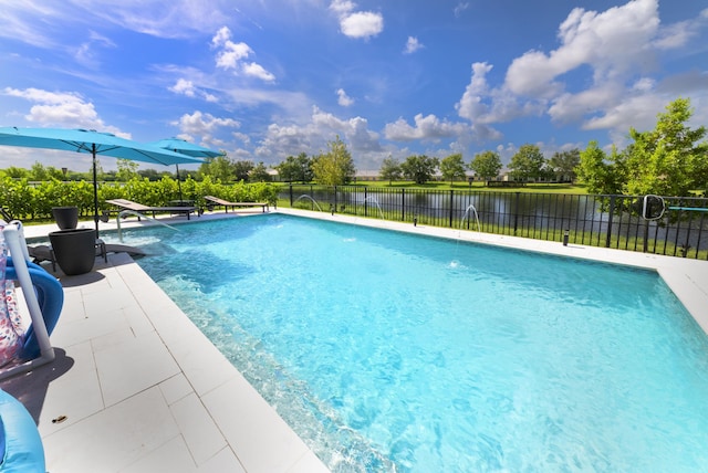 view of swimming pool featuring a water view, pool water feature, and a patio