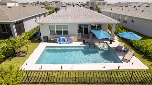 rear view of house featuring a patio area and a yard