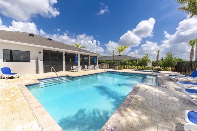 view of pool featuring a patio area and an in ground hot tub