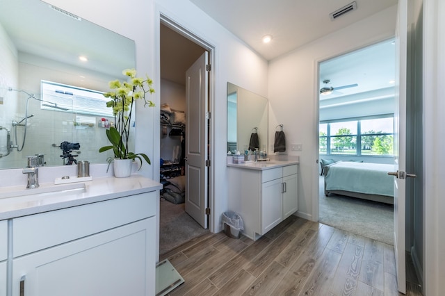 bathroom with vanity, ceiling fan, and an enclosed shower