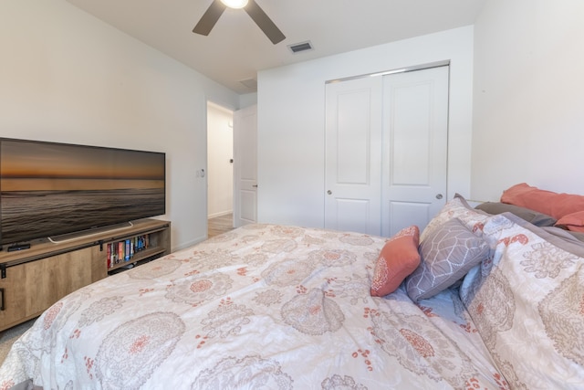 bedroom with ceiling fan and a closet