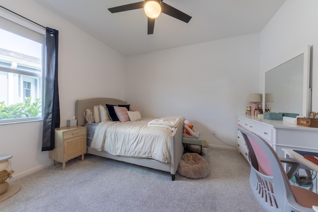 carpeted bedroom with ceiling fan and multiple windows