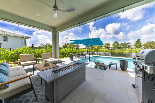 view of patio featuring a grill, an outdoor living space with a fire pit, a fenced in pool, a water view, and ceiling fan