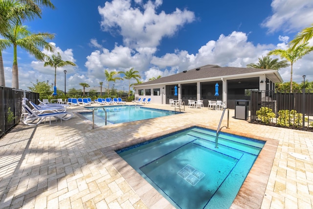 view of pool with a patio and a community hot tub