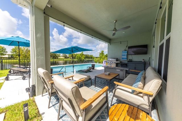 view of patio / terrace with grilling area, a fenced in pool, and pool water feature