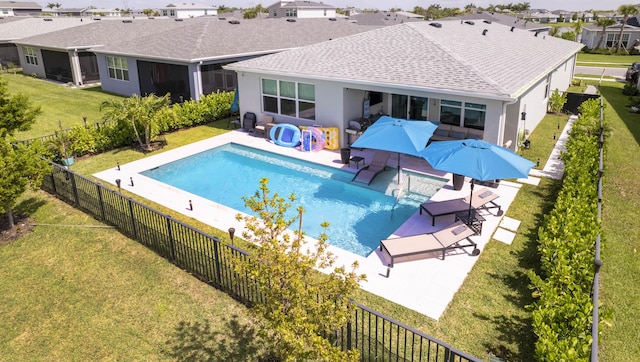 view of pool featuring a lawn and a patio