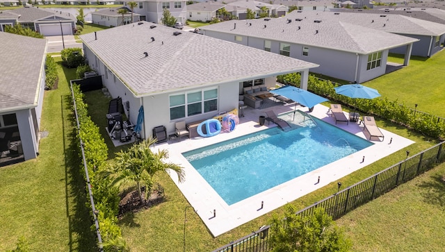 view of swimming pool with a lawn and a patio area