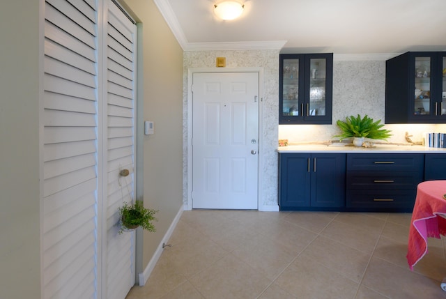 interior space with tile patterned floors, vanity, and ornamental molding