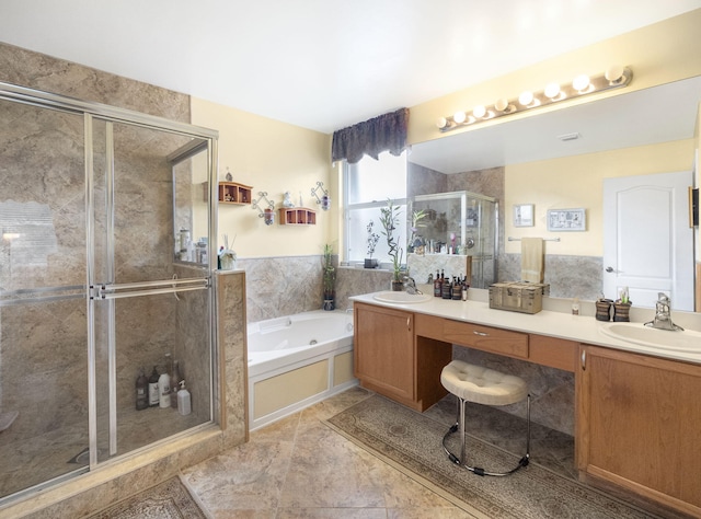 bathroom with vanity and independent shower and bath