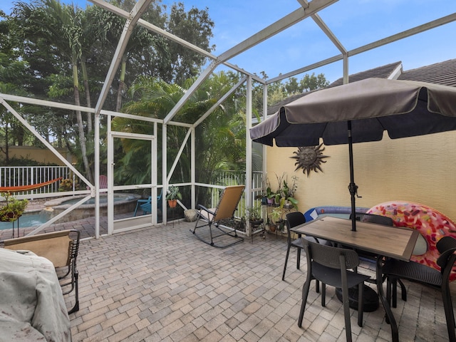 view of patio / terrace featuring a lanai and a pool with hot tub