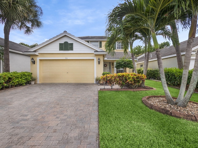 view of front facade with a front yard and a garage