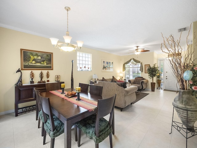 dining area with plenty of natural light, ceiling fan with notable chandelier, and ornamental molding