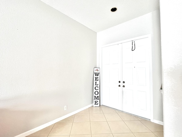 tiled foyer entrance with lofted ceiling