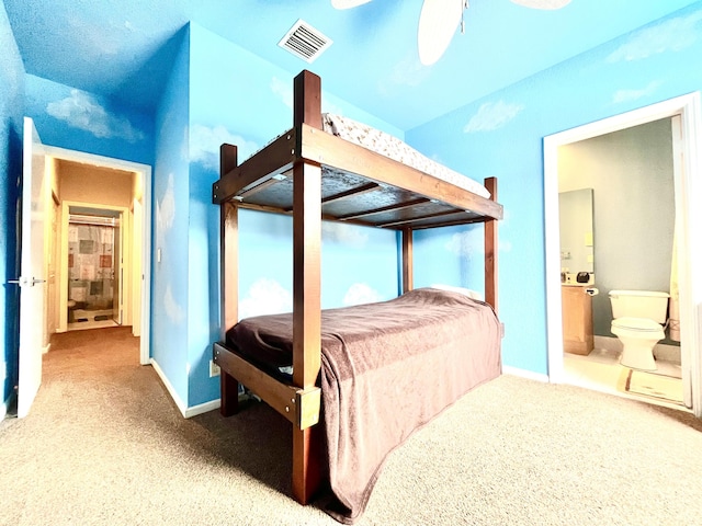 carpeted bedroom with ceiling fan and connected bathroom