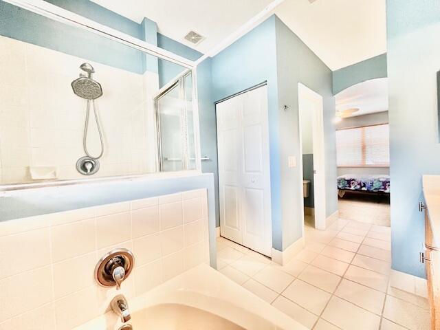 bathroom with independent shower and bath and tile patterned flooring