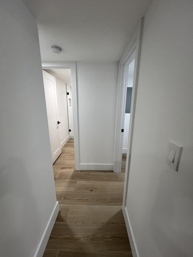 hallway with light hardwood / wood-style flooring