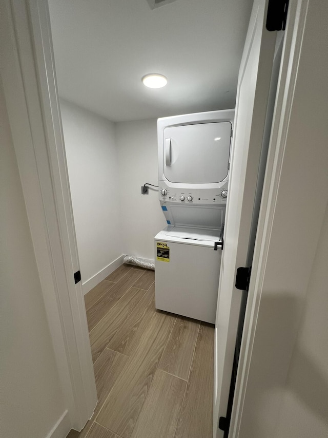 clothes washing area featuring stacked washer / dryer