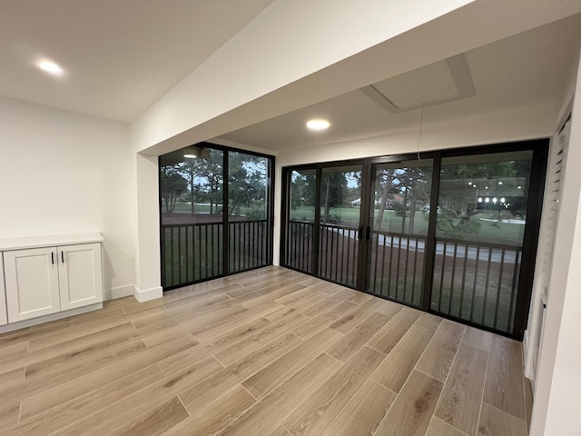 unfurnished sunroom featuring lofted ceiling